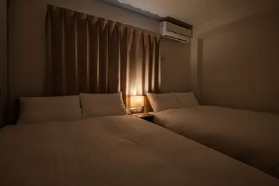 two beds in a small room with a window at Noah Ikebukuro / Vacation STAY 7297 in Tokyo