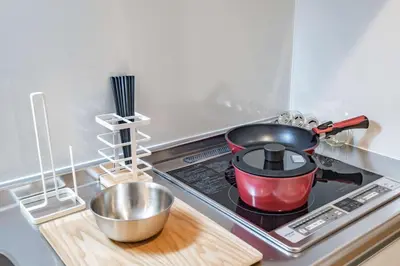 a red pot sitting on top of a stove in a kitchen at Noah Ikebukuro / Vacation STAY 7325 in Tokyo