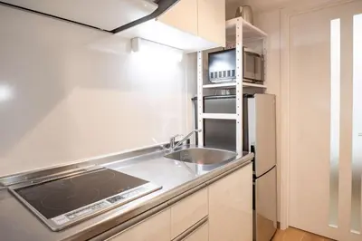 a small kitchen with a sink and a refrigerator at Noah Ikebukuro / Vacation STAY 7298 in Tokyo