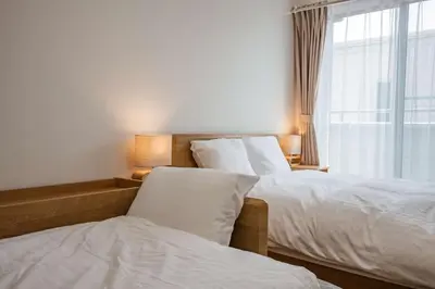 two beds in a hotel room with a window at Noah Ikebukuro / Vacation STAY 7298 in Tokyo