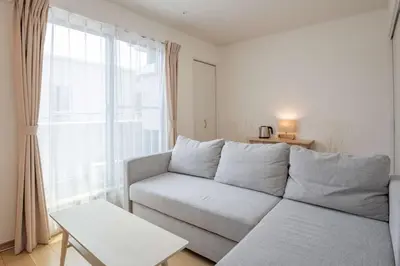 a living room with a couch and a window at Noah Ikebukuro / Vacation STAY 7296 in Tokyo