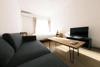 a living room with a couch and a tv and a bed at Noah Ikebukuro / Vacation STAY 7294 in Tokyo