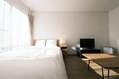 a bedroom with a bed and a table and a television at Noah Ikebukuro / Vacation STAY 7294 in Tokyo