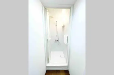 a bathroom with a mirror and a shower at SunStay - Tachiaigawa 1 in Tokyo