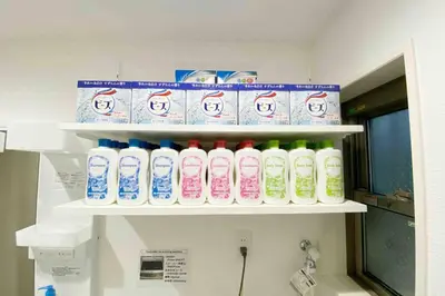 a shelf filled with lots of bottles of milk at SunStay - Tachiaigawa 1 in Tokyo