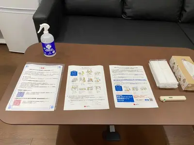 a coffee table with books and a bottle of water on it at SunStay - Tachiaigawa 1 in Tokyo