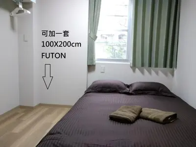 a bed with two pillows on it in a bedroom at Issyuku Higashiueno Hotel in Tokyo
