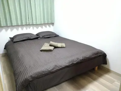 a bed with two towels and two pillows on it at Issyuku Higashiueno Hotel in Tokyo