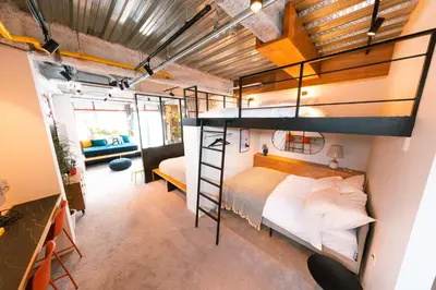 a loft bedroom with a bunk bed and a couch at illi Esu Nakano in Tokyo