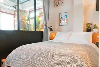 a bedroom with a bed and a window at illi Esu Nakano in Tokyo