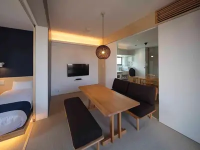 a room with a dining table and a bedroom at East SQUARE Tokyo in Tokyo