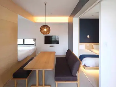 a room with a dining table and a bedroom at East SQUARE Tokyo in Tokyo