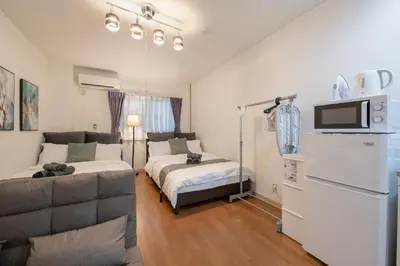 a living room with a couch and a tv in it at Asakusa Panda Hostel in Tokyo