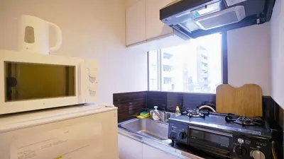 a kitchen with a sink and a microwave at TOKYO ICHIBAN ASAKUSA in Tokyo