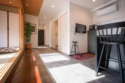 a living room with a couch and a table at Tsubame Hotel Asakusabashi 3 minutes walk from Asakusabashi Station Near Asakusa, Akihabara, and Ueno Cooking utensils and kitchen washing machine available Direct access to Haneda and Narita airports in Tokyo