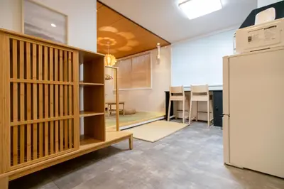 a kitchen and dining room with a refrigerator at Tsubame Hotel Asakusabashi 3 minutes walk from Asakusabashi Station Near Asakusa, Akihabara, and Ueno Cooking utensils and kitchen washing machine available Direct access to Haneda and Narita airports in Tokyo