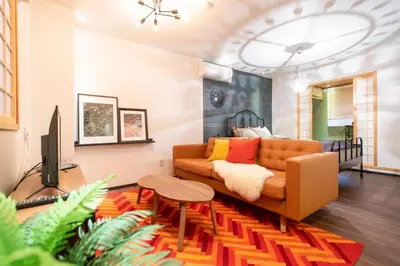a living room with a couch and a table at Tsubame Hotel Asakusabashi 3 minutes walk from Asakusabashi Station Near Asakusa, Akihabara, and Ueno Cooking utensils and kitchen washing machine available Direct access to Haneda and Narita airports in Tokyo