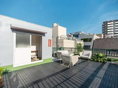 a balcony with chairs and tables on a building at Tsubame Hotel Asakusabashi 3 minutes walk from Asakusabashi Station Near Asakusa, Akihabara, and Ueno Cooking utensils and kitchen washing machine available Direct access to Haneda and Narita airports in Tokyo