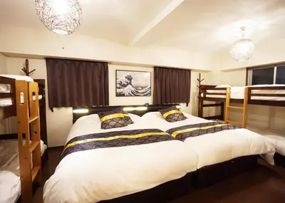 a bedroom with a large bed and two bunk beds at Taito-ku - Apartment / Vacation STAY 80790 in Tokyo