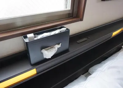 a box of tissues sitting on the side of a bed at Taito-ku - Apartment / Vacation STAY 80790 in Tokyo