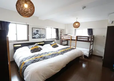 two beds in a room with two windows at Taito-ku - Apartment / Vacation STAY 80790 in Tokyo