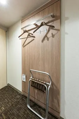 a chair in a room with a wooden wall at Hotel Kazusaya in Tokyo