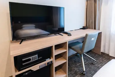 a television sitting on a desk in a room at Hotel Kazusaya in Tokyo
