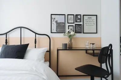 a bedroom with a bed and a desk with a chair at Miyako Shinjuku Hotel \u90fd-\u65b0\u5bbf- in Tokyo