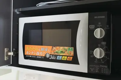 a microwave oven with a package of food inside at Miyako Shinjuku Hotel \u90fd-\u65b0\u5bbf- in Tokyo
