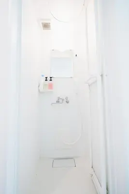 a white bathroom with a shower and a sink at Miyako Shinjuku Hotel \u90fd-\u65b0\u5bbf- in Tokyo