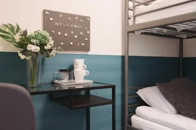 a table with a vase of flowers on a bed at Miyako Shinjuku Hotel \u90fd-\u65b0\u5bbf- in Tokyo