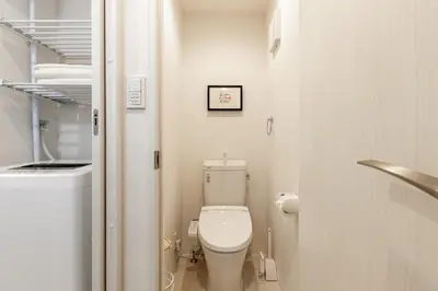 a small bathroom with a toilet and a sink at Home Sweet Office Heiwajima in Tokyo