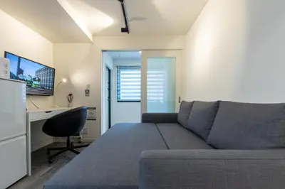 a living room with a couch and a desk at Home Sweet Office Heiwajima in Tokyo