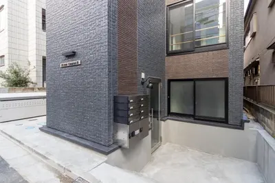 a building with a brick wall with a dresser on it at Home Sweet Office Heiwajima in Tokyo