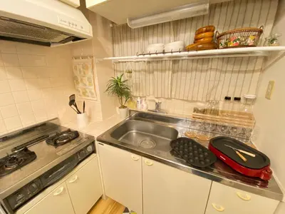 a small kitchen with a sink and a stove at Yoyogi Apartment 2-401 by Tranova in Tokyo