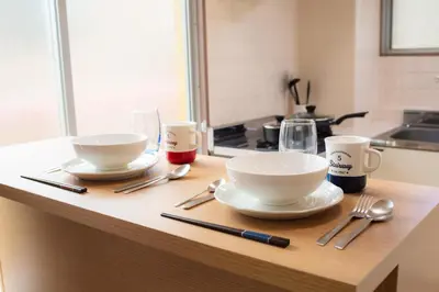 a kitchen counter with two bowls and utensils on it at Yoyogi Apartment 2-401 by Tranova in Tokyo