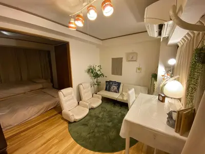 a bedroom with a bed and a table and chairs at Yoyogi Apartment 2-401 by Tranova in Tokyo
