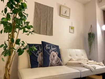 a living room with a couch with two pillows of a dog at Yoyogi Apartment 2-401 by Tranova in Tokyo