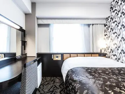 a hotel room with a bed and a large window at APA Hotel Roppongi SIX in Tokyo