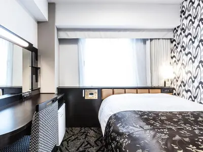 a hotel room with a bed and a large window at APA Hotel Roppongi SIX in Tokyo