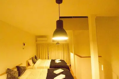 a bedroom with a bed and a light at \u30a2\u30f3\u30c9\u30b9\u30c6\u30a4\u6cbc\u888b in Tokyo