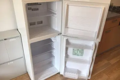 a white refrigerator with its door open in a kitchen at \u30a2\u30f3\u30c9\u30b9\u30c6\u30a4\u6cbc\u888b in Tokyo