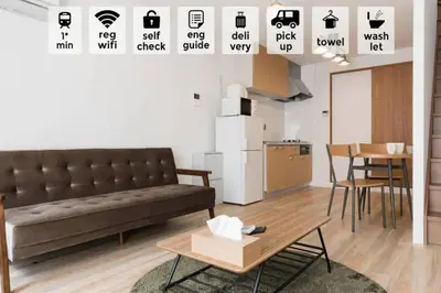 a living room with a couch and a table at \u30a2\u30f3\u30c9\u30b9\u30c6\u30a4\u6cbc\u888b in Tokyo