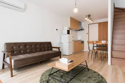 a living room with a couch and a table at \u30a2\u30f3\u30c9\u30b9\u30c6\u30a4\u6cbc\u888b in Tokyo