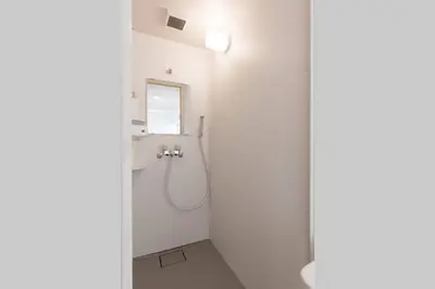 a bathroom with a shower with a sink and a mirror at \u30a2\u30f3\u30c9\u30b9\u30c6\u30a4\u6cbc\u888b in Tokyo