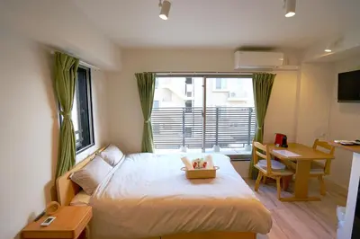 a bedroom with a bed and a desk and a window at Jeffery Skytree Residence Tokyo in Tokyo