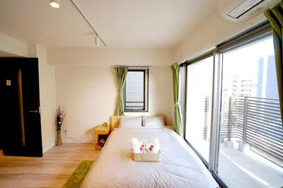 a bedroom with a bed and a large window at Jeffery Skytree Residence Tokyo in Tokyo