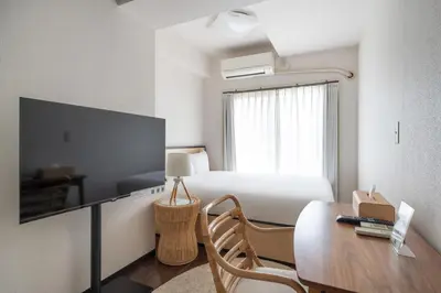 a room with a bed and a desk and a table at Elm\u9ad8\u7530\u99ac\u5834 in Tokyo