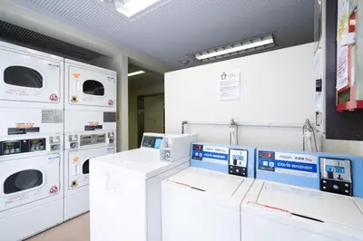 a laundry room with washers and dryers on display at Elm\u9ad8\u7530\u99ac\u5834 in Tokyo