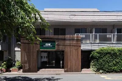 a building with a sign that reads at Elm\u9ad8\u7530\u99ac\u5834 in Tokyo